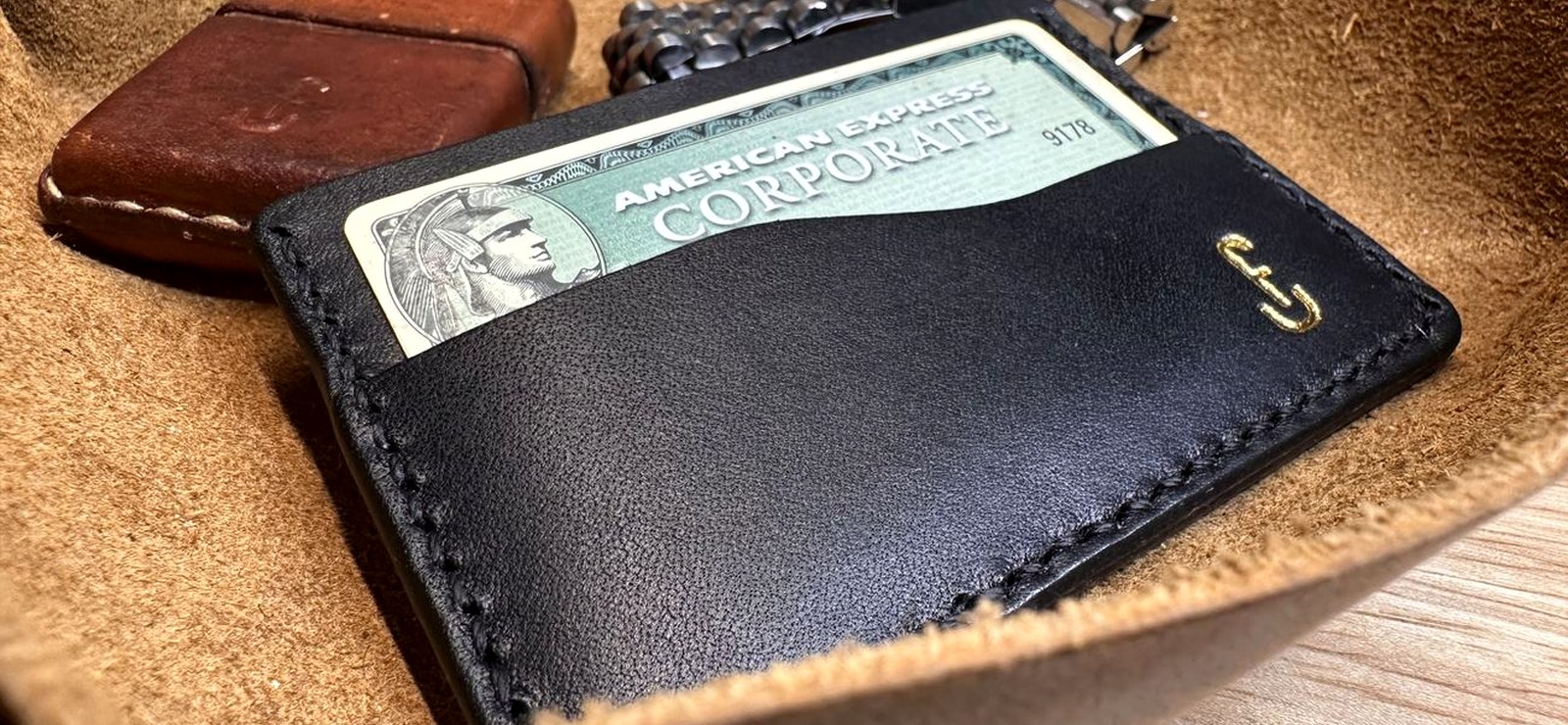 A slim two-tone racing-green and caviar leather card wallet