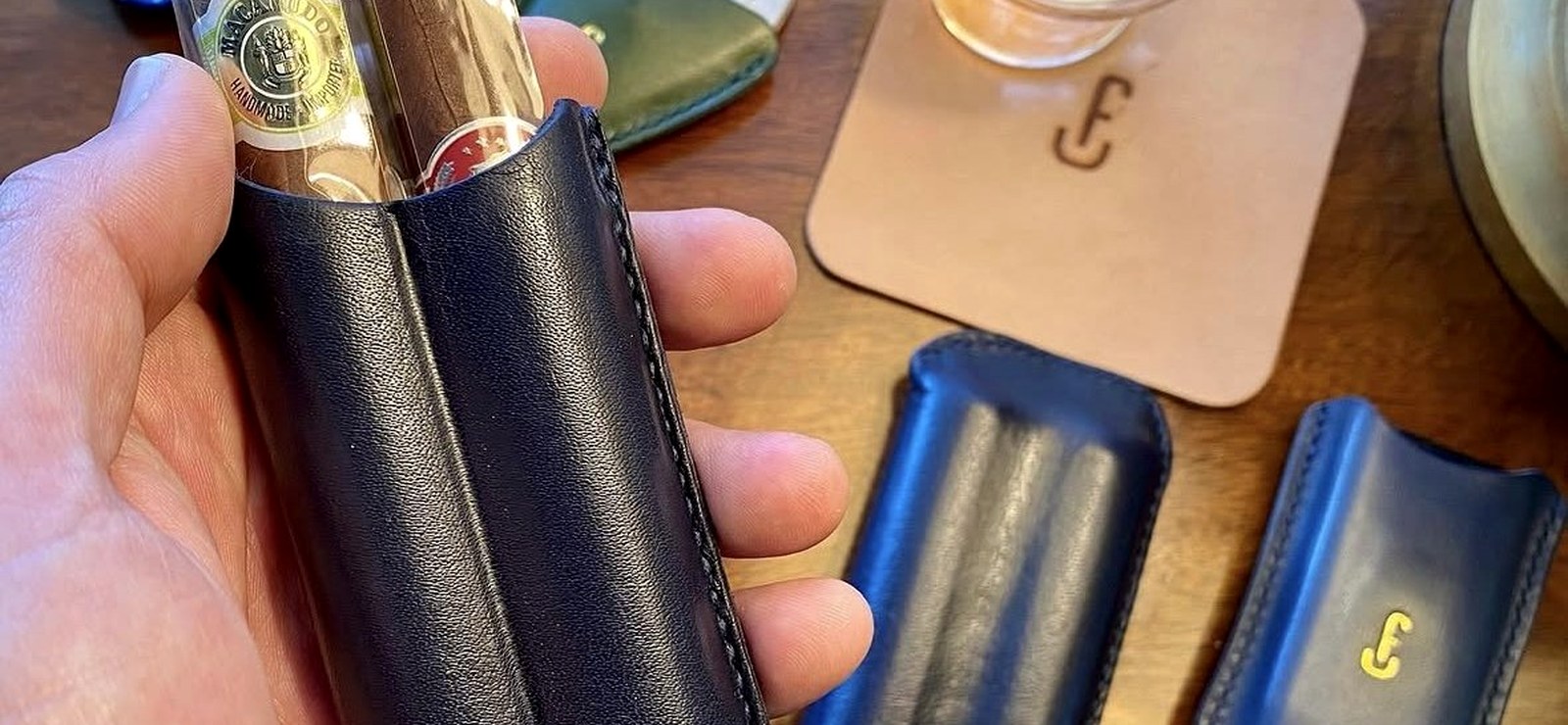 Flores Tamez handmade leather cigar cases and card wallets on a table